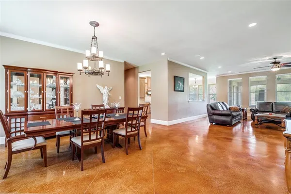 a view of a dining room with furniture a chandelier and wooden floor