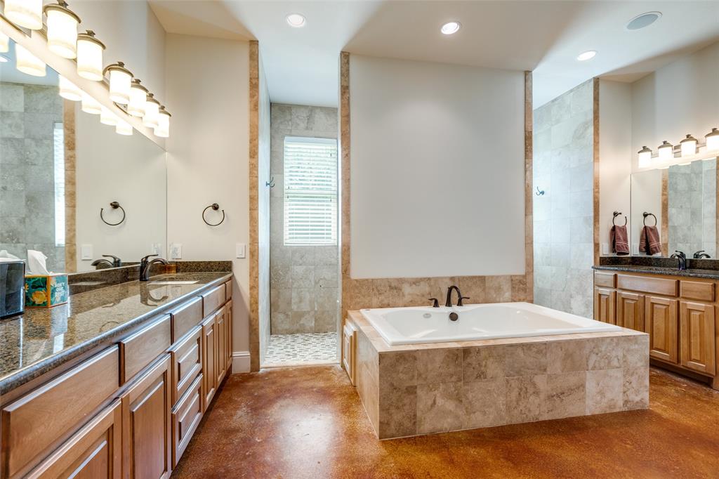 643 County Road 2255 Telephone, TX 75488 - Photo 32 of 40 Bathroom featuring two vanities, a bath, recessed lighting, walk in shower, and finished concrete flooring