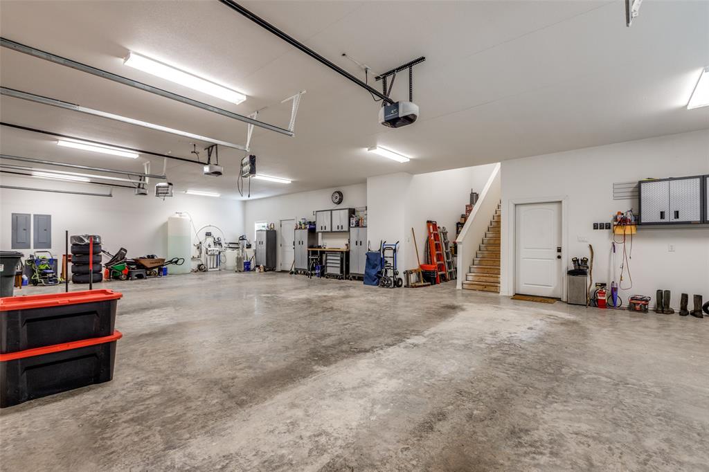 643 County Road 2255 Telephone, TX 75488 - Photo 36 of 40 Garage with electric panel and a garage door opener