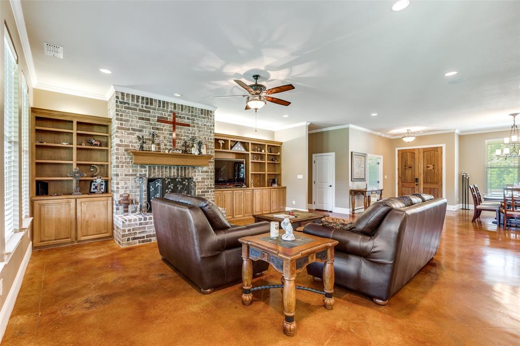 643 County Road 2255 Telephone, TX 75488 - Photo 9 of 40 Living area featuring finished concrete flooring, a fireplace, recessed lighting, crown molding, and ceiling fan