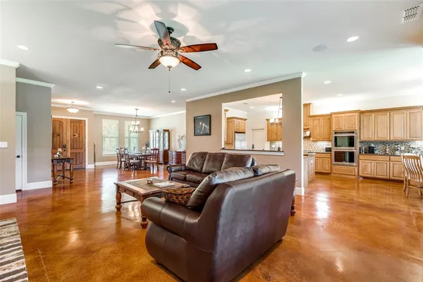 a living room with furniture and kitchen view
