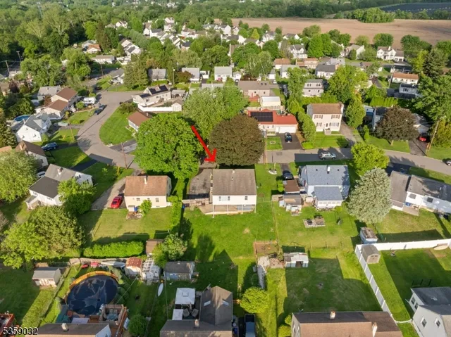 an aerial view of residential houses with outdoor space and street view