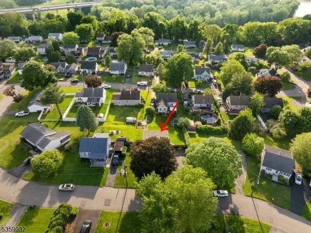 an aerial view of residential houses with outdoor space and street view