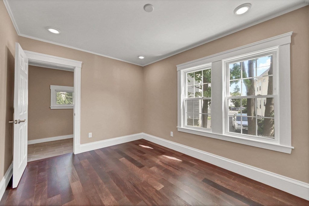 1540 Mystic Valley Parkway, Unit 1 Medford, MA 02155 - Photo 12 of 17 wooden floor in an empty room with a window