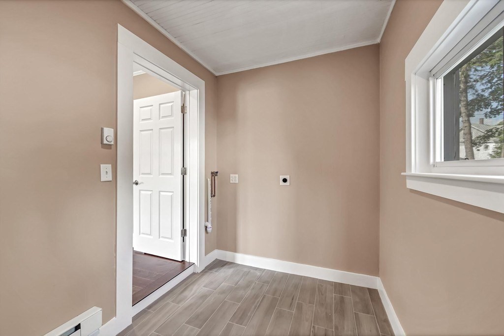 1540 Mystic Valley Parkway, Unit 1 Medford, MA 02155 - Photo 13 of 17 an empty room with wooden floor and windows