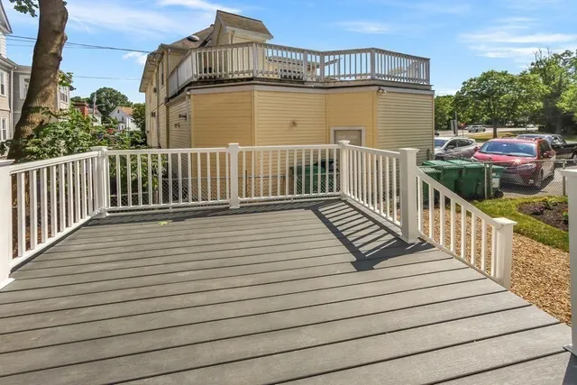 a view of a balcony with wooden floor