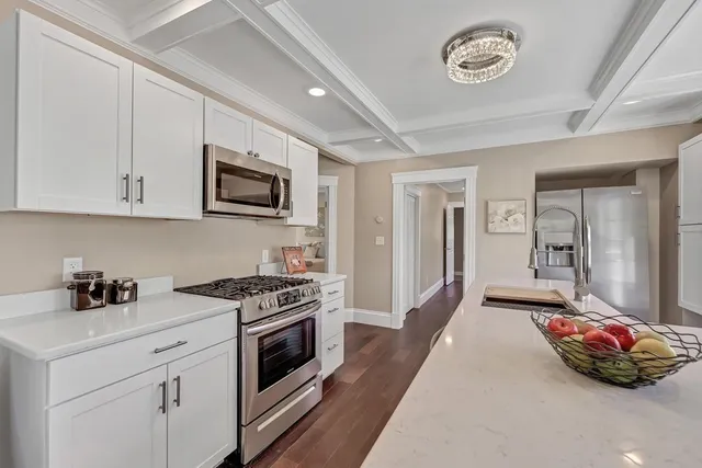 a kitchen with a stove and a white cabinets