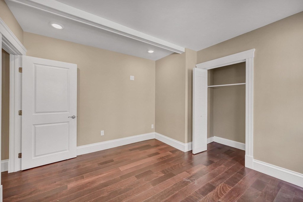 1540 Mystic Valley Parkway, Unit 1 Medford, MA 02155 - Photo 7 of 17 an empty room with wooden floor & closet area