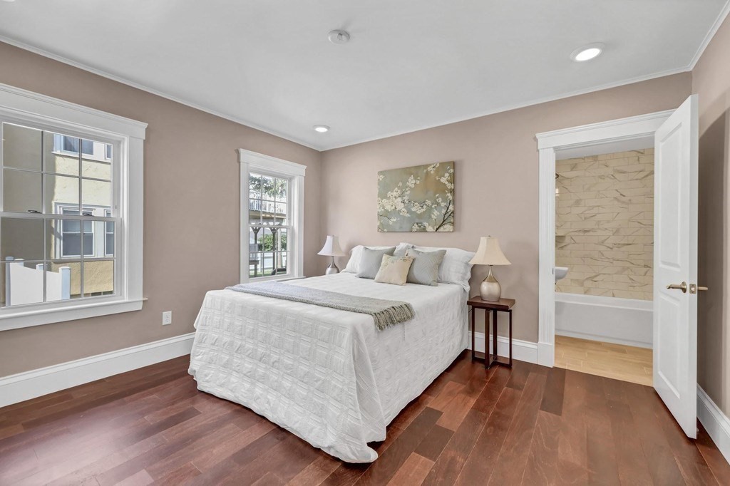 1540 Mystic Valley Parkway, Unit 1 Medford, MA 02155 - Photo 8 of 17 a spacious bedroom with a bed and a large window