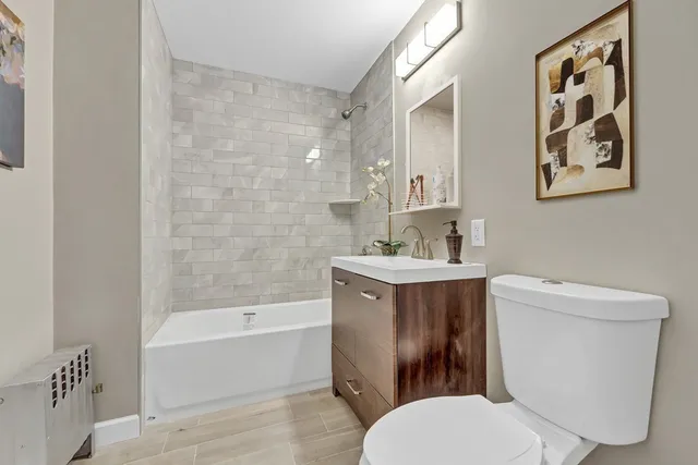 a bathroom with a toilet a sink and bathtub