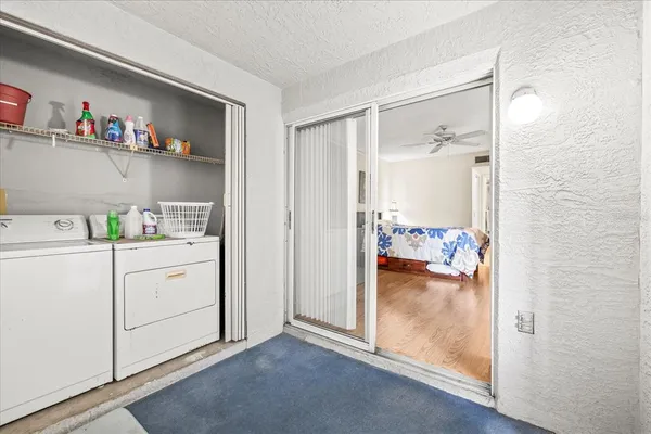 a storage room with a wooden floor washer and dryer