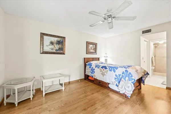 a bed sitting in a bedroom and with couch