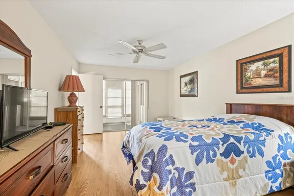 a bedroom with a bed and a flat screen tv