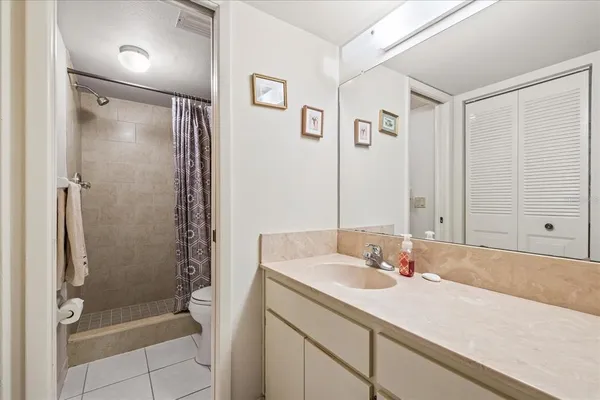 a bathroom with a shower sink and mirror