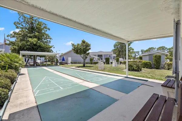 a swimming pool with outdoor seating and yard