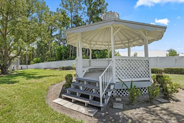 a view of a patio with a table and chairs under an umbrella