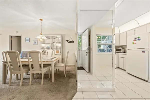 a view dining table chairs and refrigerator