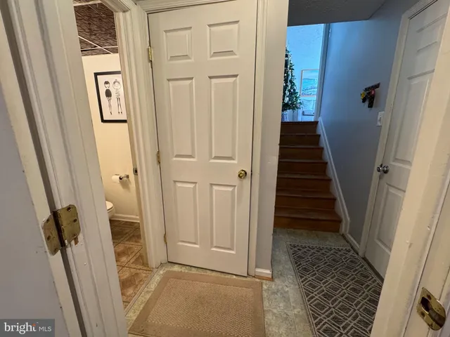a view of a hallway with wooden floor and entryway