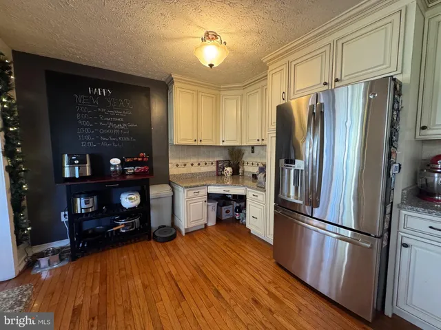 a kitchen with stainless steel appliances a refrigerator stove and microwave