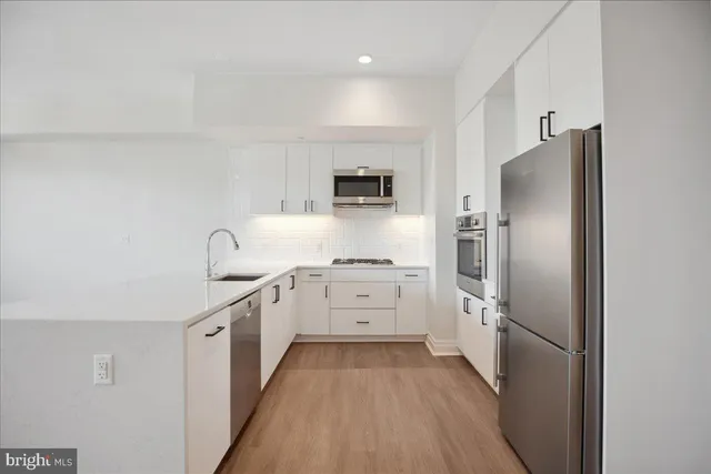 a kitchen with refrigerator and cabinets