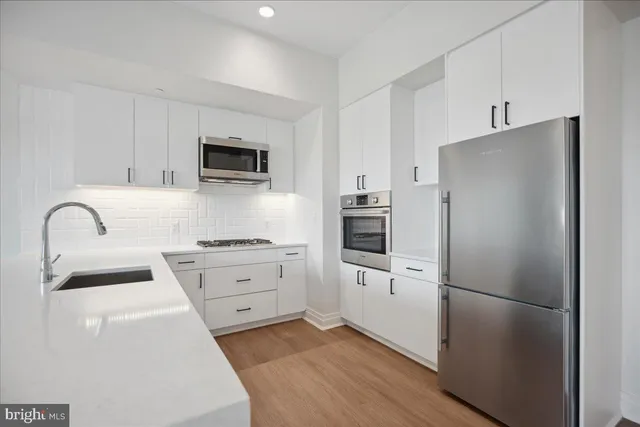 a kitchen with a sink and a refrigerator