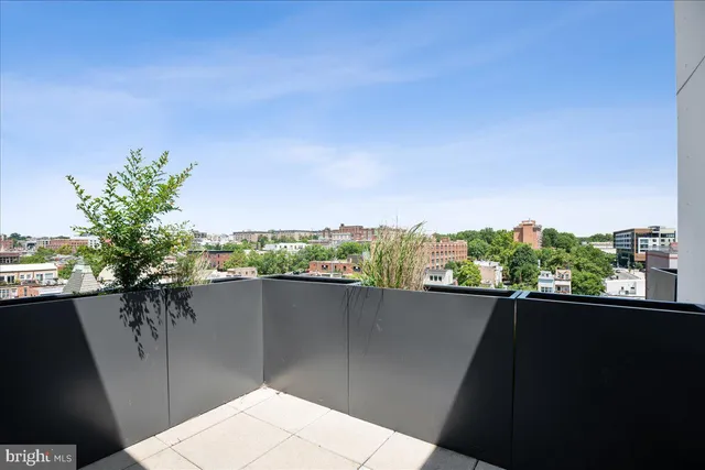 a view of a balcony with an outdoor seating