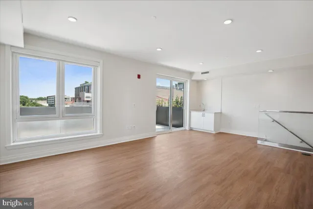 a bathroom with a glass shower door and a sink