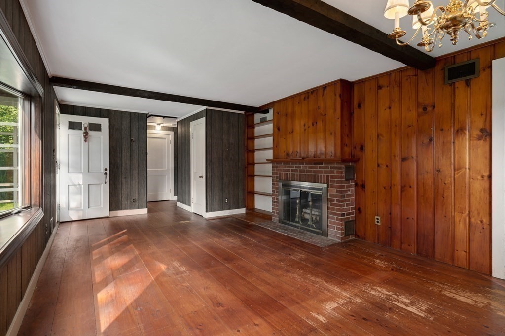 163 Topsfield Road Ipswich, MA 01938 - Photo 14 of 29 a view of an empty room with a fireplace and a window