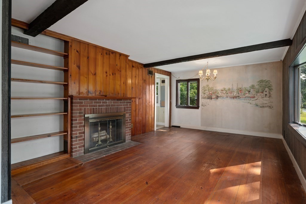 163 Topsfield Road Ipswich, MA 01938 - Photo 15 of 29 a view of empty room with wooden floor and fireplace