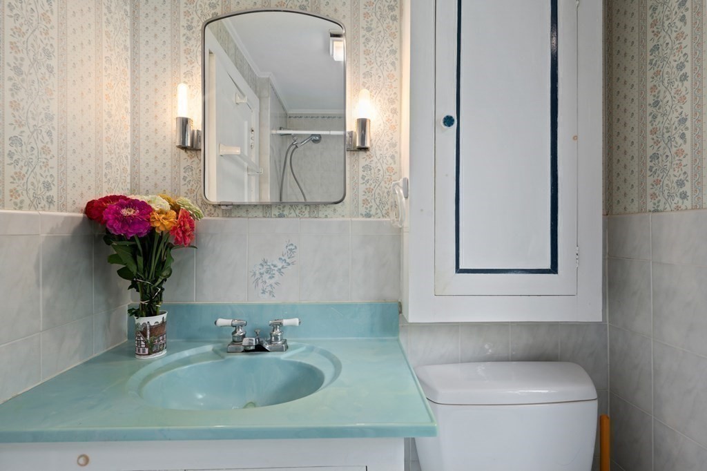 163 Topsfield Road Ipswich, MA 01938 - Photo 20 of 29 a bathroom with a sink toilet and mirror