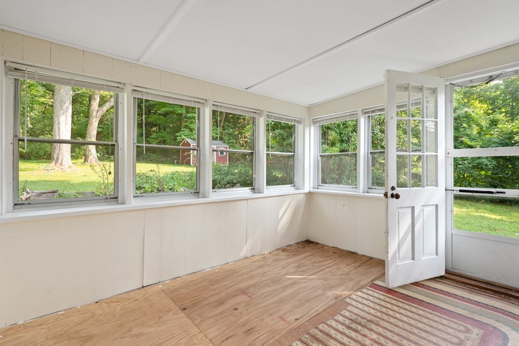 163 Topsfield Road Ipswich, MA 01938 - Photo 2 of 29 a view of an empty room with wooden floor and a window