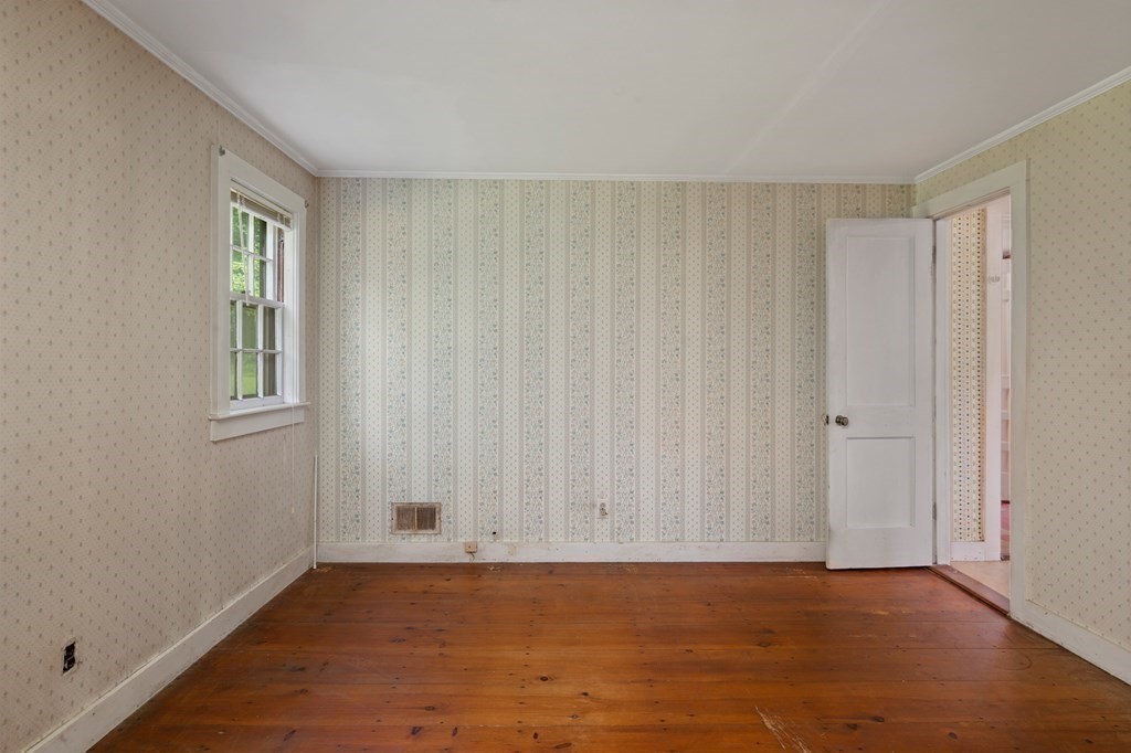 163 Topsfield Road Ipswich, MA 01938 - Photo 21 of 29 a view of an empty room with window and hardwood floor