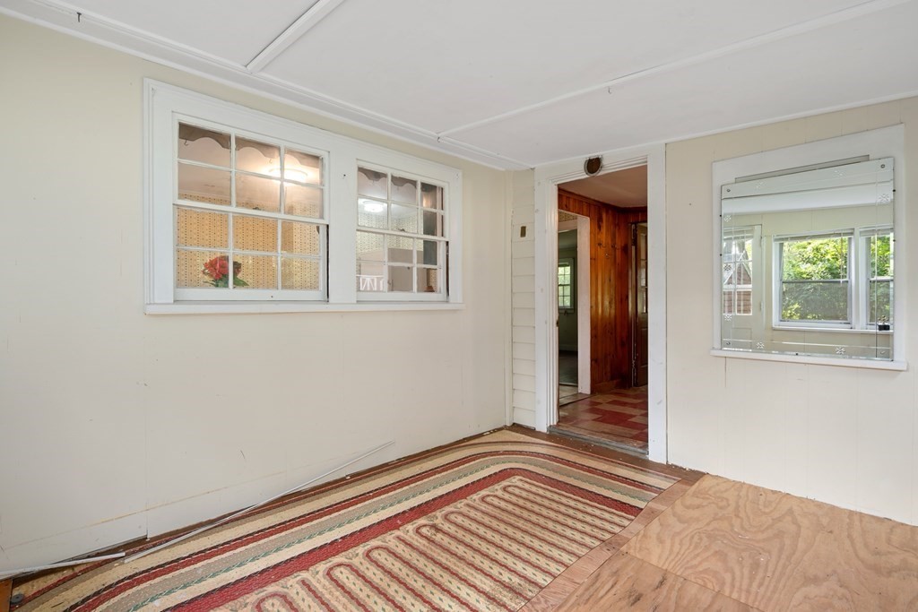 163 Topsfield Road Ipswich, MA 01938 - Photo 3 of 29 a view of a room with wooden floor and windows