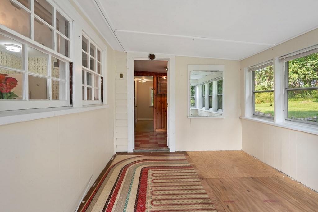 163 Topsfield Road Ipswich, MA 01938 - Photo 4 of 29 a view of a bedroom with wooden floor and a window
