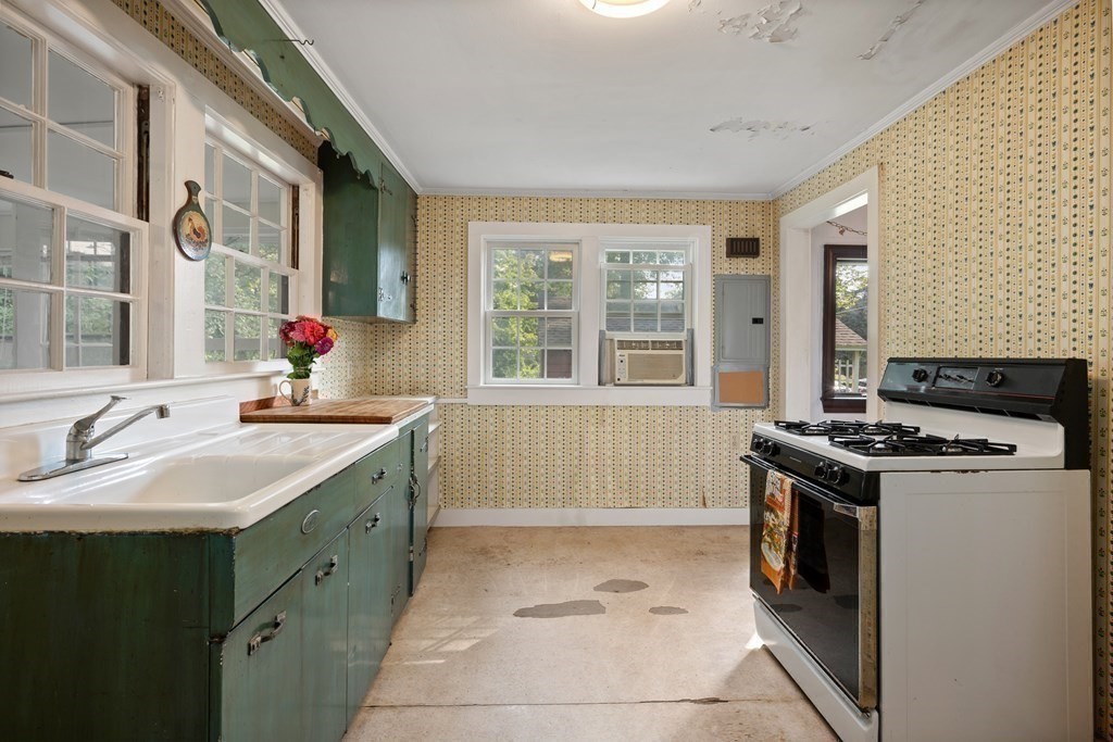 163 Topsfield Road Ipswich, MA 01938 - Photo 8 of 29 a kitchen with a sink stove and cabinets