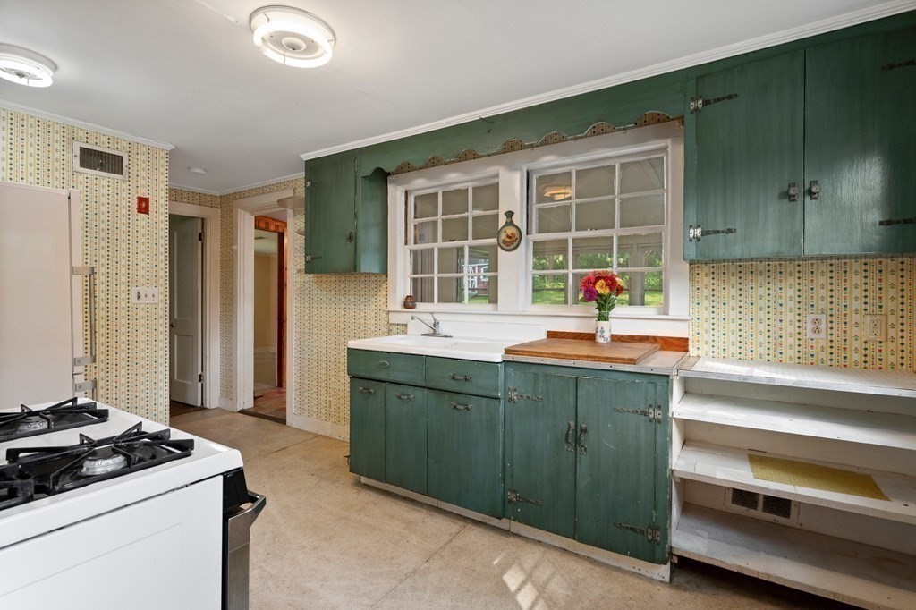 163 Topsfield Road Ipswich, MA 01938 - Photo 9 of 29 a kitchen with a sink and a stove top oven