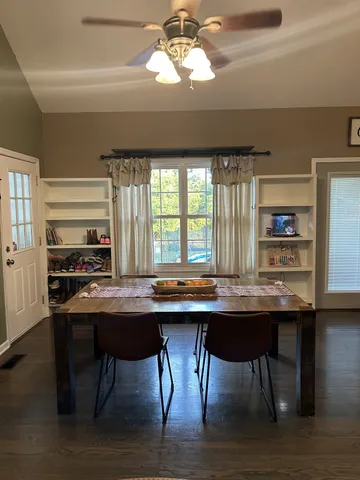 a kitchen with a table chairs and wooden floor
