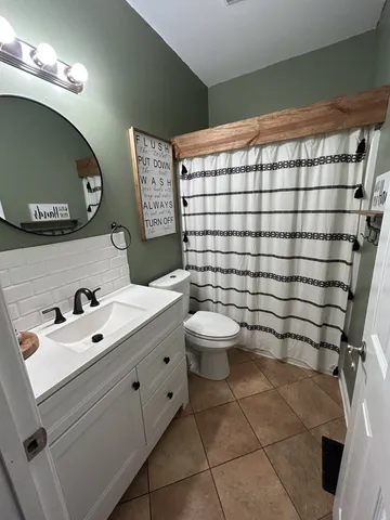 a bathroom with a toilet sink and shower