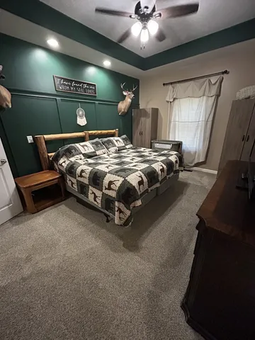 a bed room with a bed and a chandelier