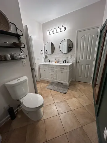 a bathroom with a sink toilet and mirror