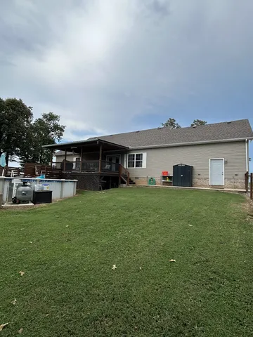 a front view of a house with a garden and trees