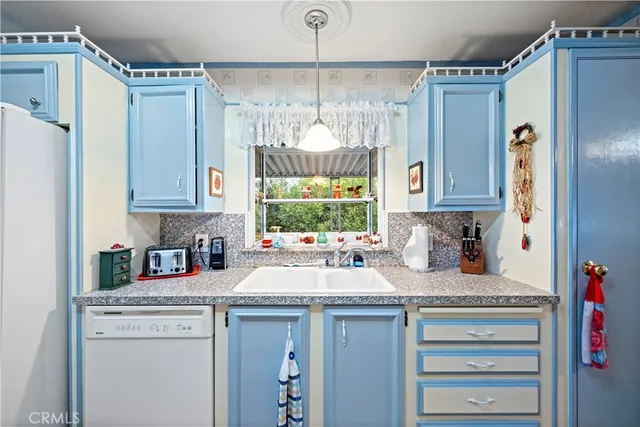 a kitchen with refrigerator and window