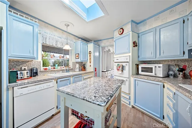 a kitchen with stainless steel appliances granite countertop a stove and a sink