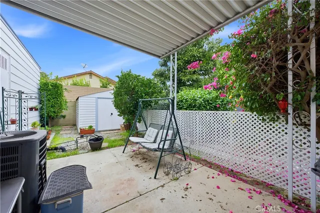 a view of a chairs and table in the backyard