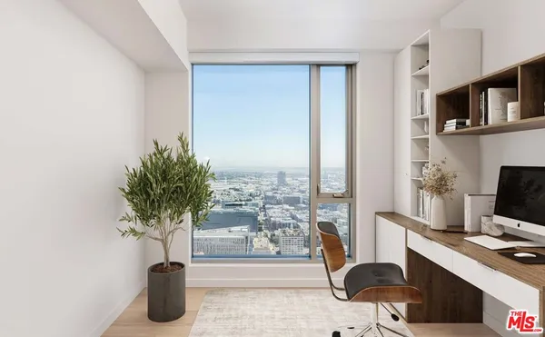 a view of a workspace with furniture and a potted plant