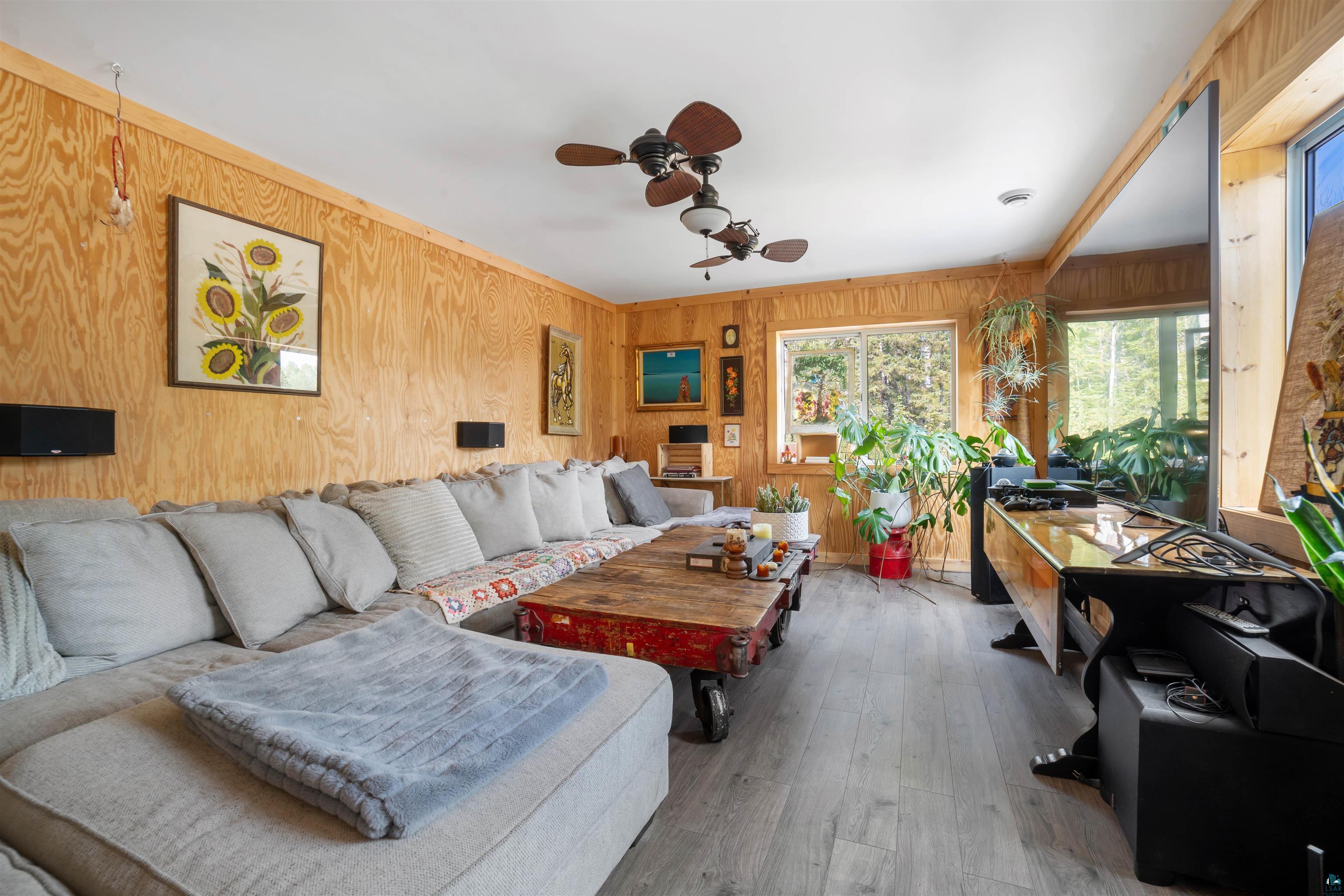 1159 East County Rd B Foxboro, WI 54836 - Photo 13 of 29 Living room featuring ceiling fan, wood walls, and hardwood / wood-style floors