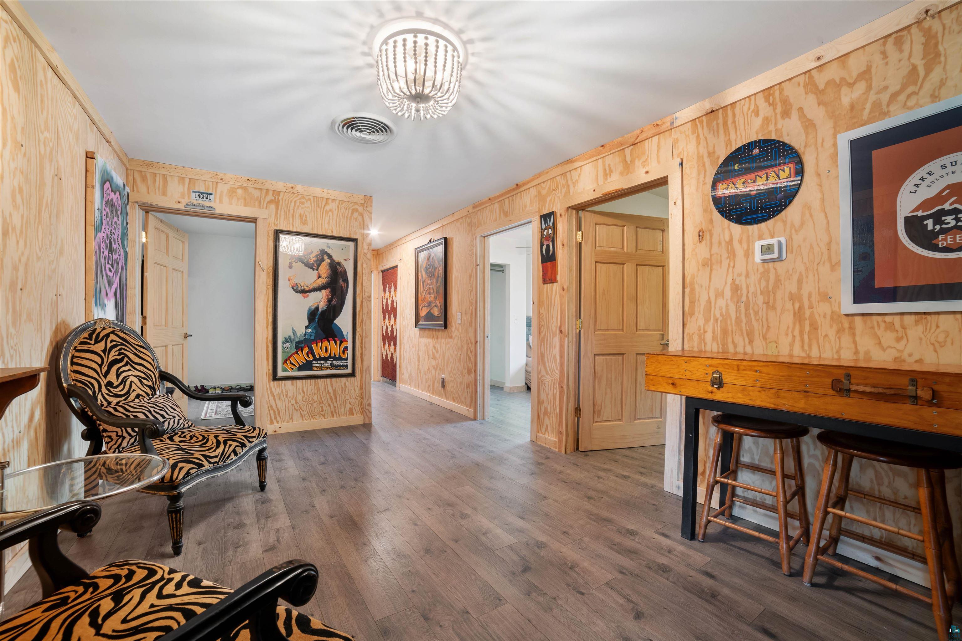 1159 East County Rd B Foxboro, WI 54836 - Photo 17 of 29 Living area featuring dark hardwood / wood-style flooring and wooden walls