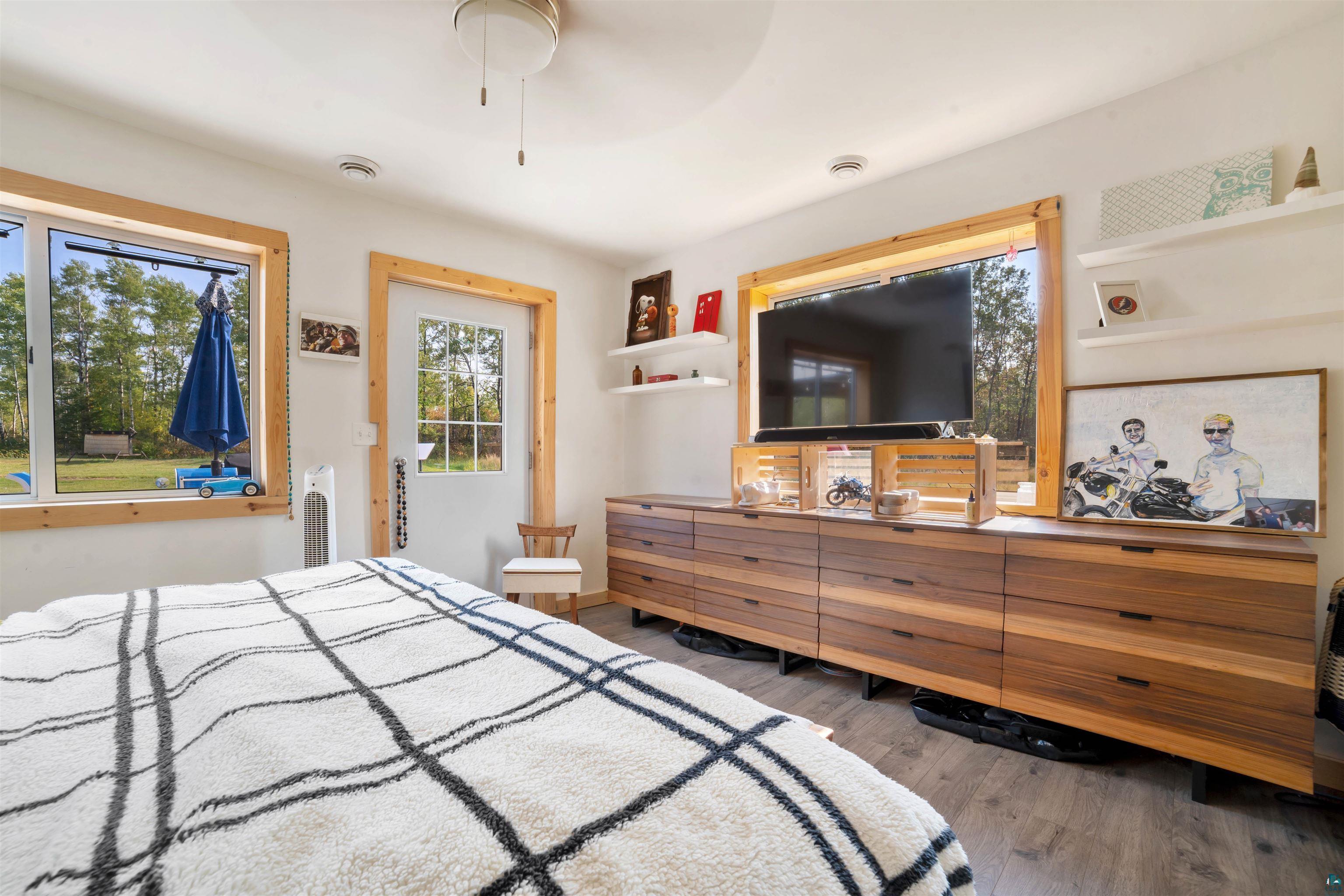 1159 East County Rd B Foxboro, WI 54836 - Photo 22 of 29 Bedroom featuring hardwood / wood-style floors and ceiling fan