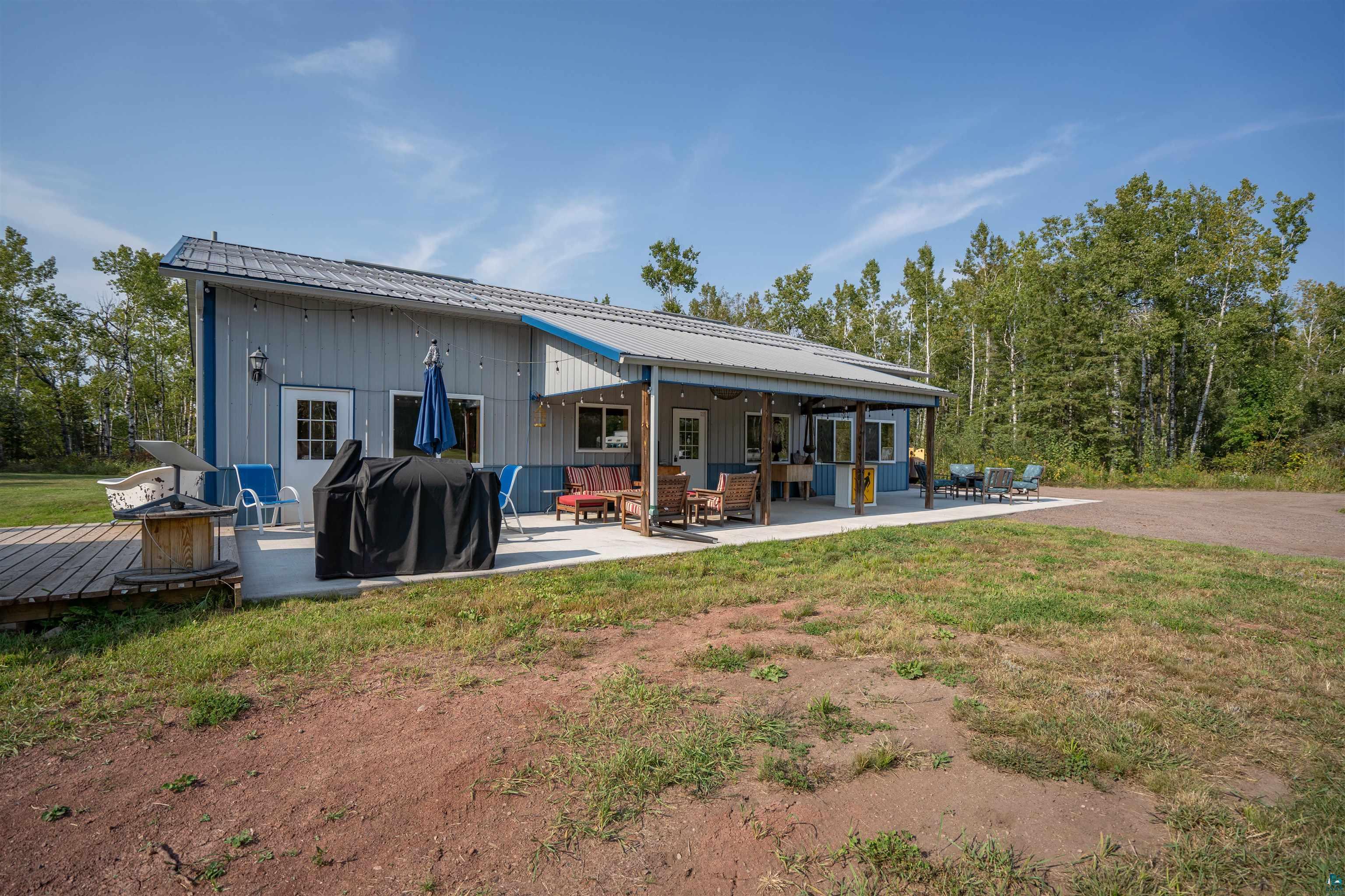 1159 East County Rd B Foxboro, WI 54836 - Photo 28 of 29 Back of property featuring a patio area and a yard