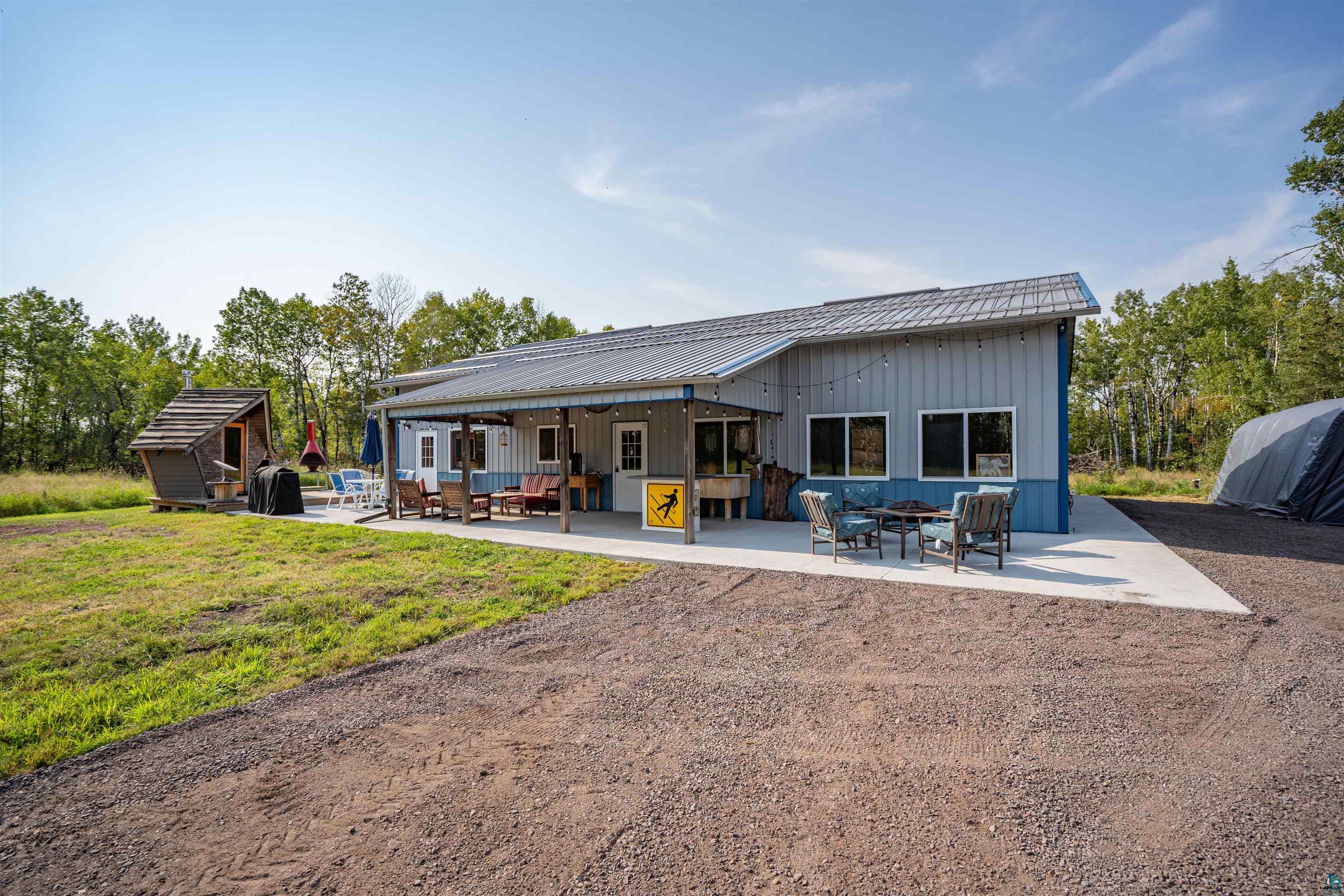 Rear view of property featuring a yard and a patio area